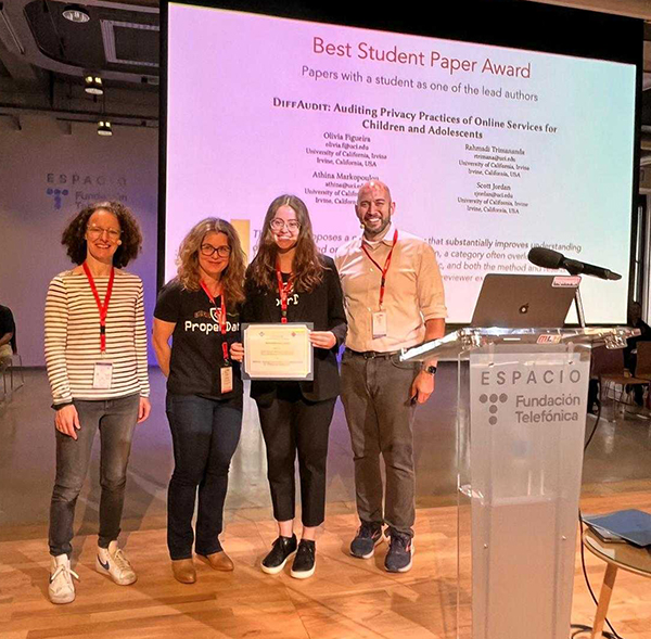 The IMC 2024 Program Committee Chairs Cristel Pelsser (left) and Dave Levin (far right) present the Best Student Paper Award to Athina Markopoulou (second from left) and Olivia Figueira. The IMC 2024 Program Committee Chairs Cristel Pelsser (left) and Dave Levin (far right) present the Best Student Paper Award to Athina Markopoulou (second from left) and Olivia Figueira.