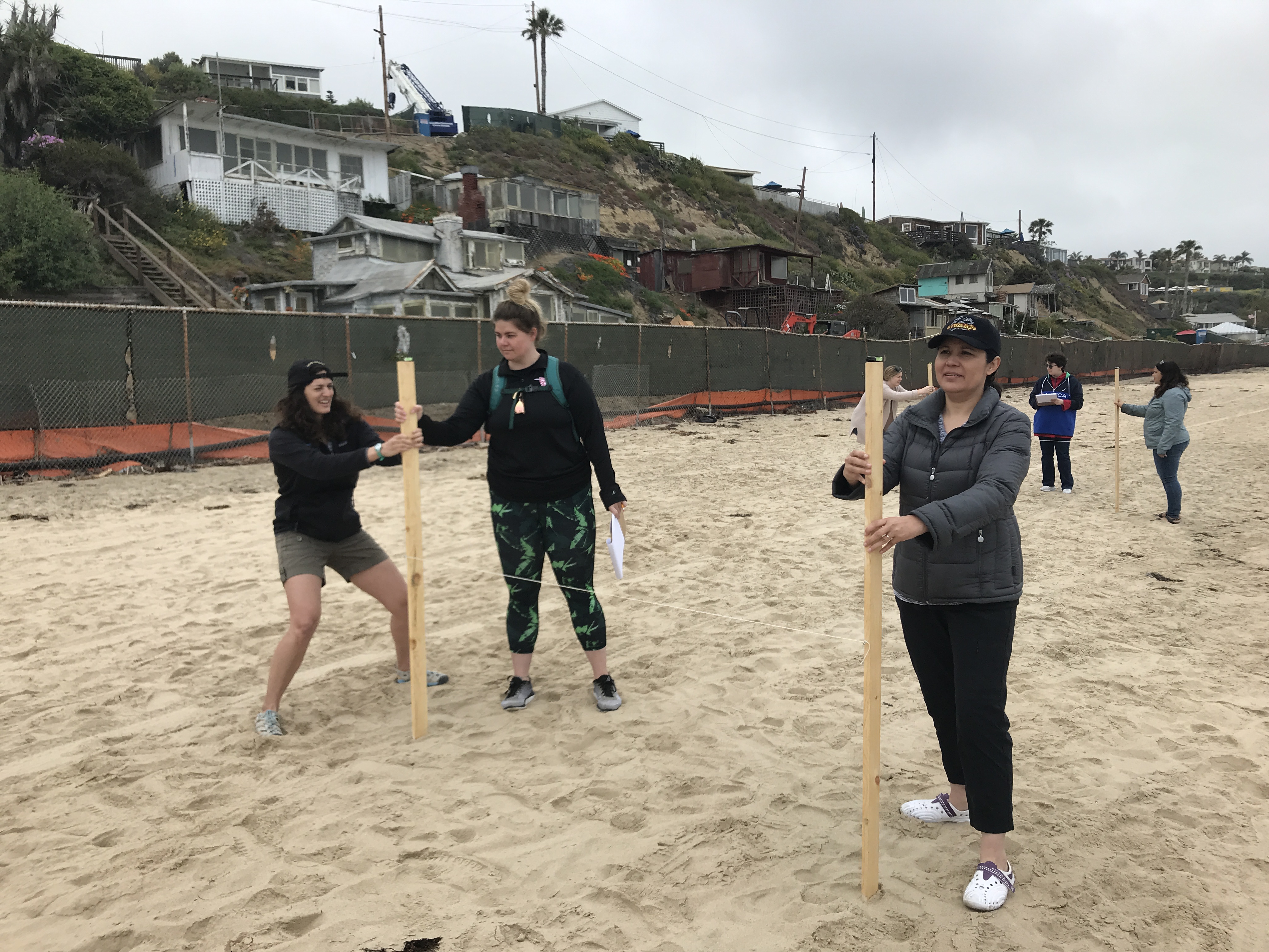 UCI students measure beach dynamics with an emery board UCI students measure beach dynamics with an emery board