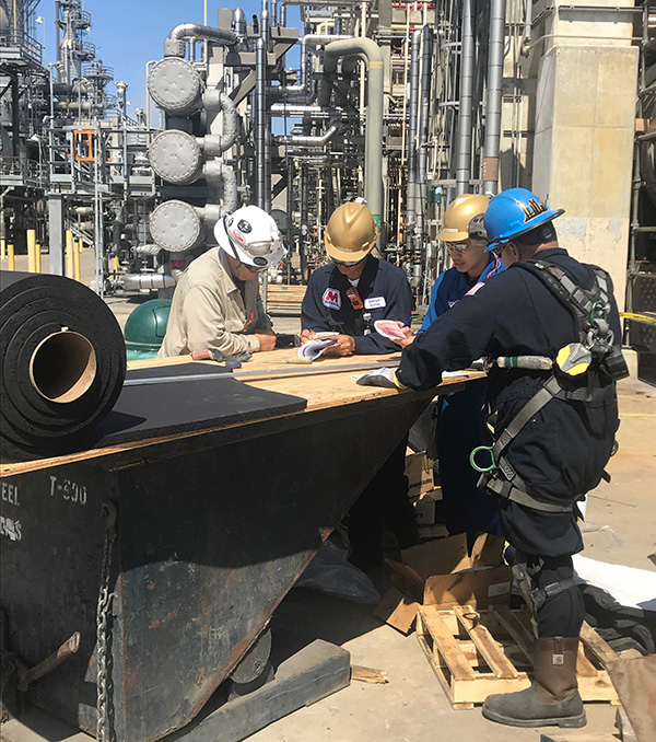 Christopher (second from right) evaluating work safety at Marathon Refinery Corporation. Christopher (second from right) evaluating work safety at Marathon Refinery Corporation