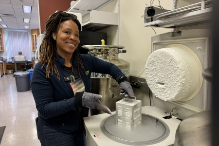 Ronke Olabisi lifts out cells stored in suspended animation at -371 in cryostorage in her UCI lab. (Photo: Natalie Tso/UCI)